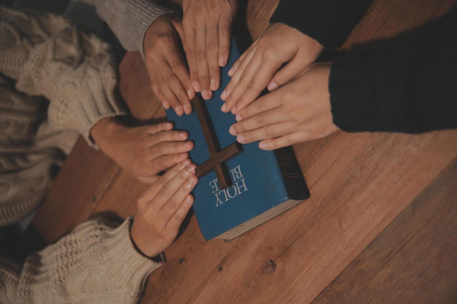 Christian group are praying to god with the bible and sharing the gospel. Concept of faith for god. photo
