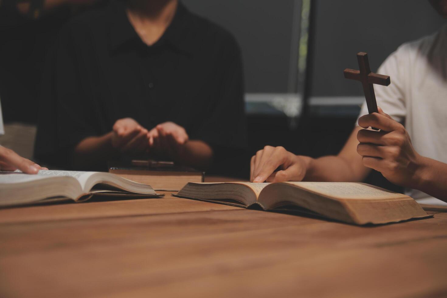 Christian group are praying to god with the bible and sharing the gospel. Concept of faith for god. photo