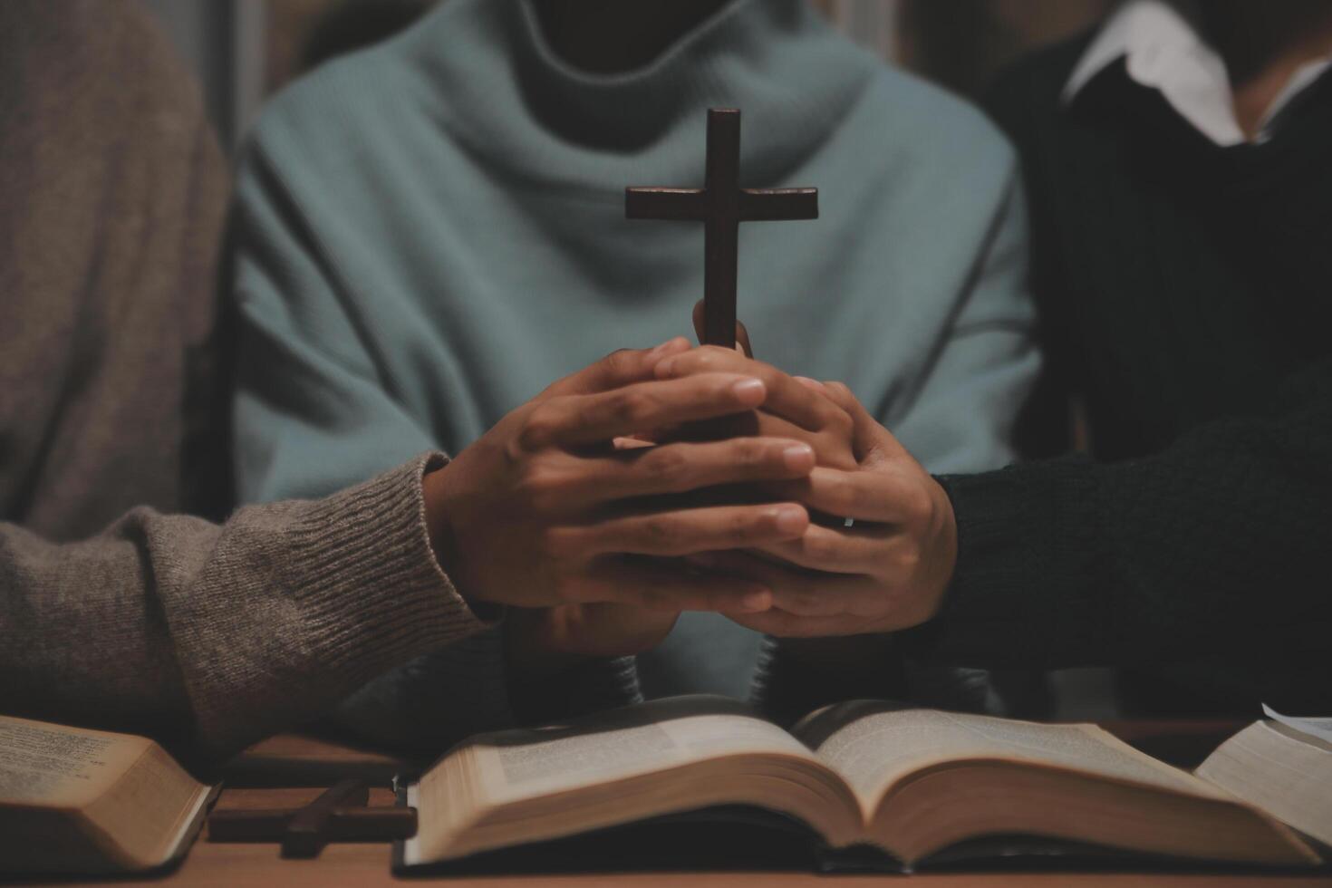 Christian group are praying to god with the bible and sharing the gospel. Concept of faith for god. photo