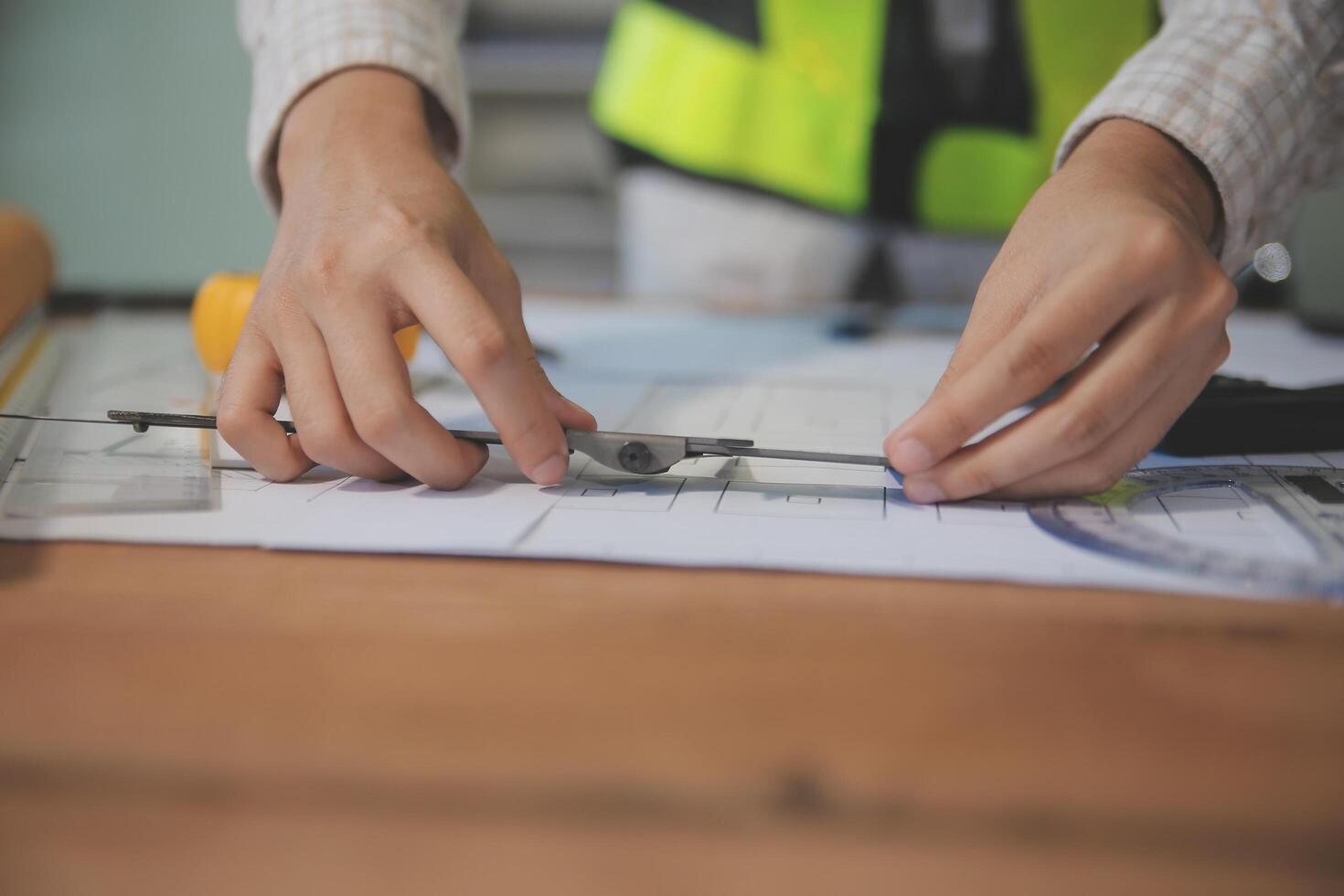 engineer people meeting working and pointing at a blueprint in office for discussing. Engineering tools and construction concept photo
