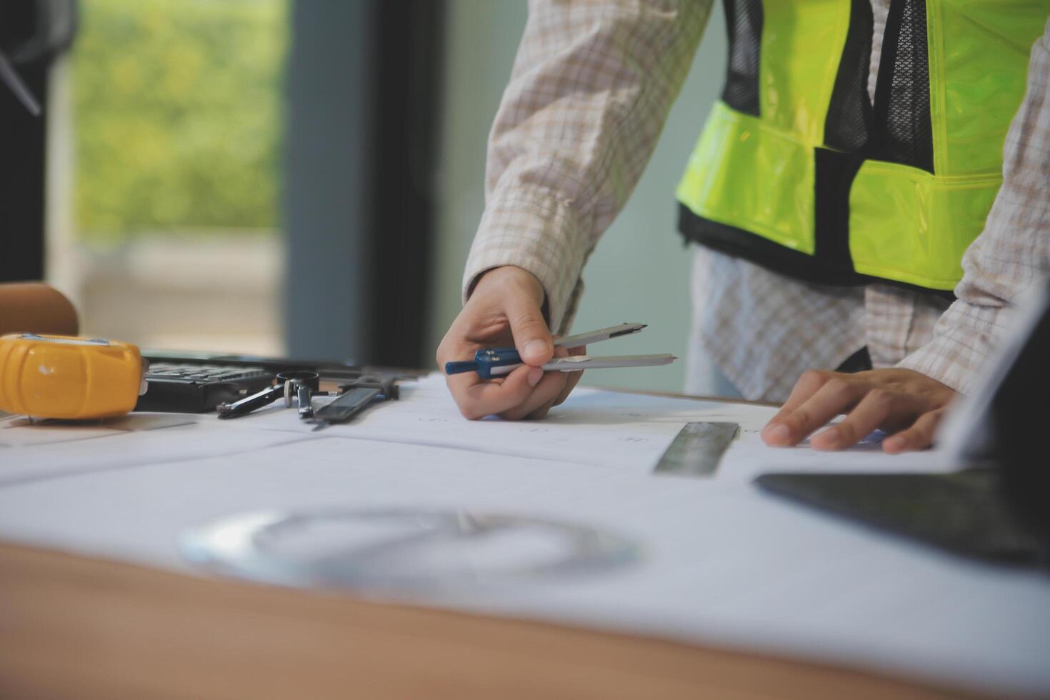 engineer people meeting working and pointing at a blueprint in office for discussing. Engineering tools and construction concept photo