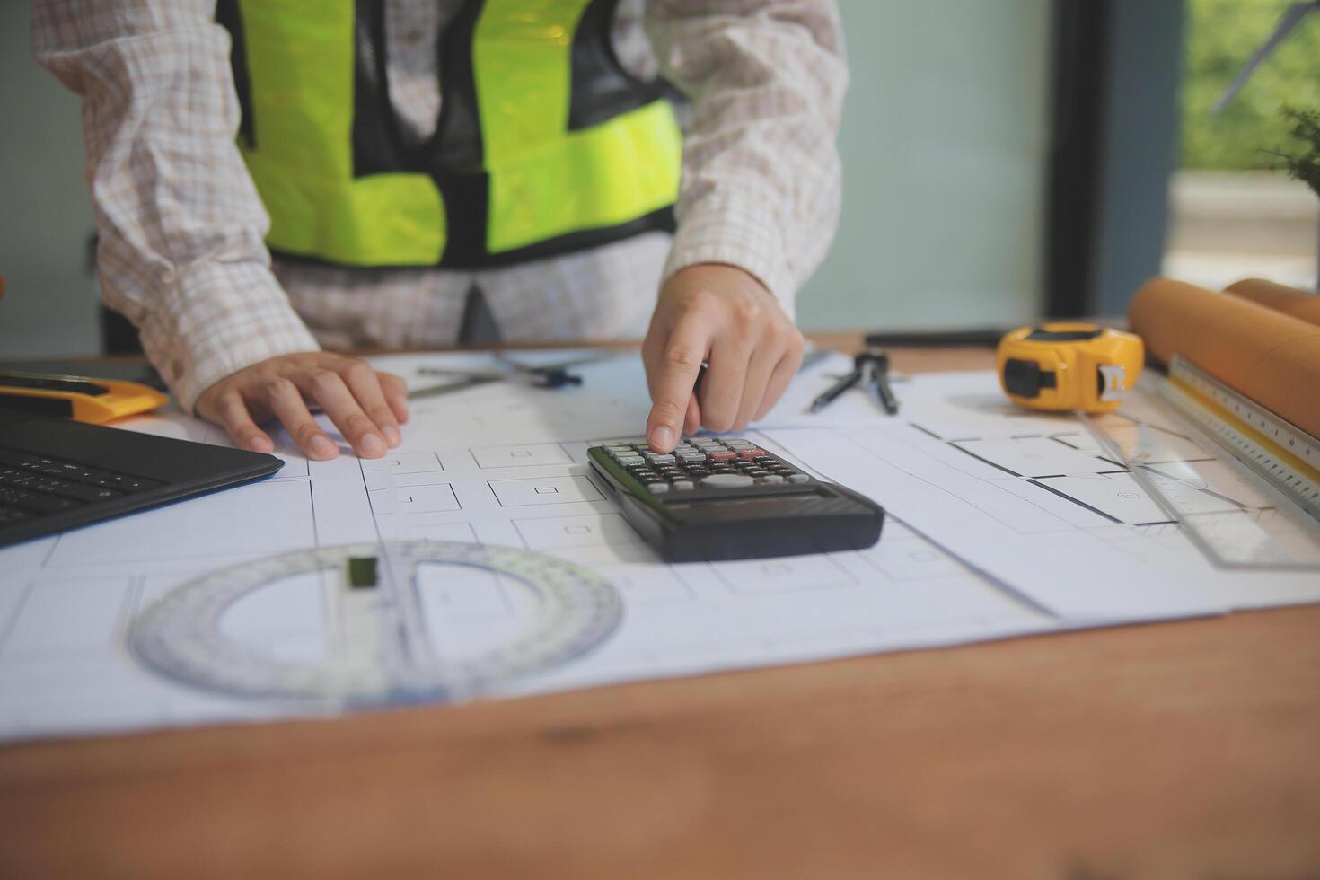 engineer people meeting working and pointing at a blueprint in office for discussing. Engineering tools and construction concept photo