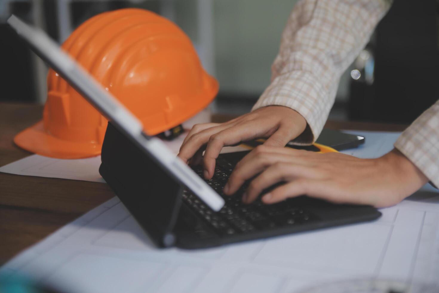 engineer people meeting working and pointing at a blueprint in office for discussing. Engineering tools and construction concept photo
