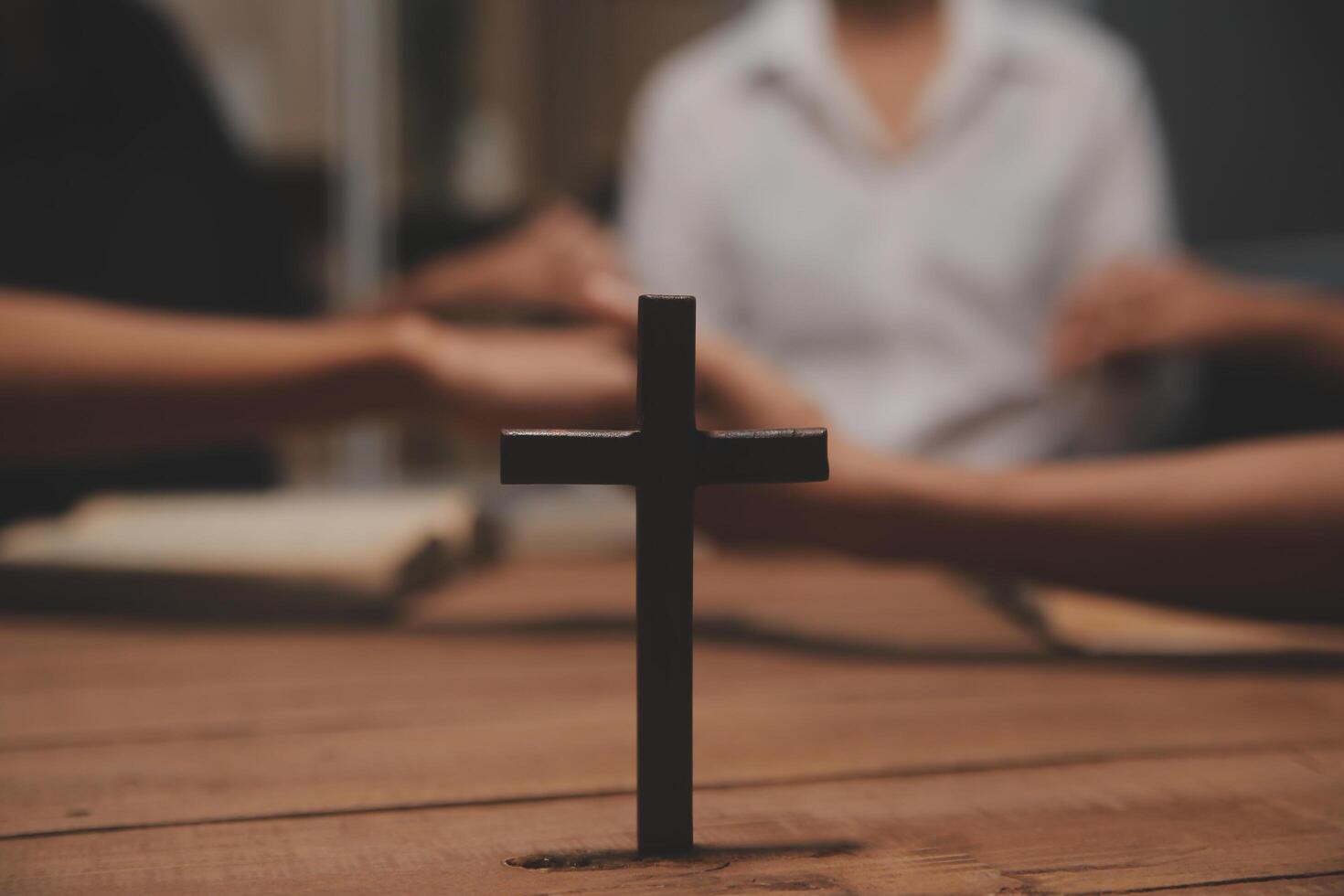 Christian group are praying to god with the bible and sharing the gospel. Concept of faith for god. photo