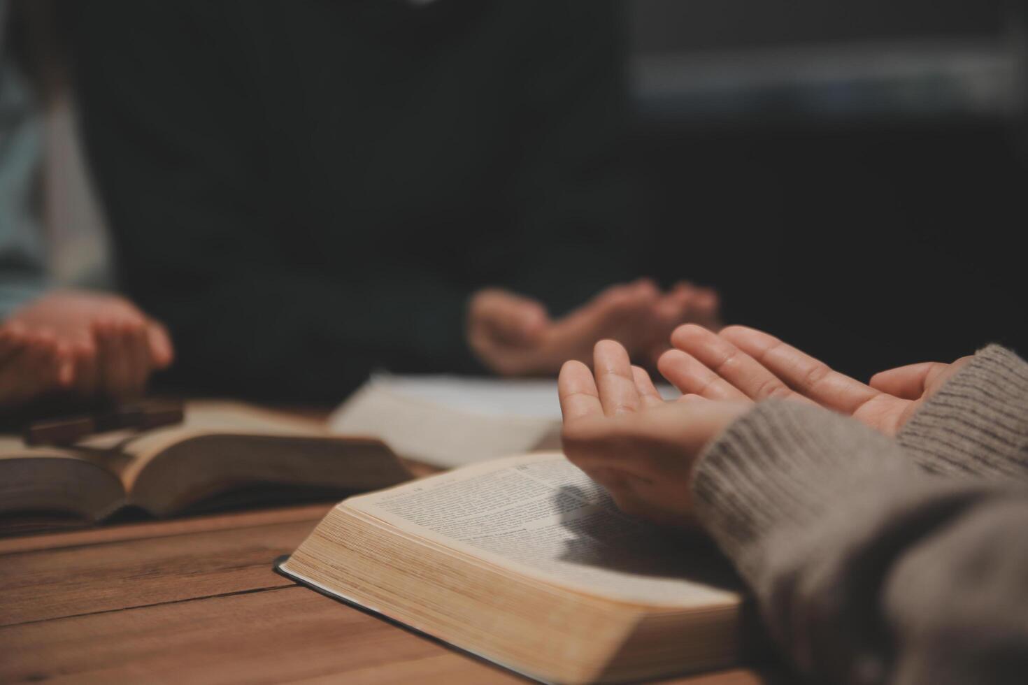 Christian group are praying to god with the bible and sharing the gospel. Concept of faith for god. photo