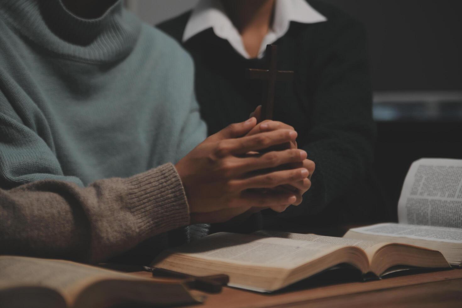 Christian group are praying to god with the bible and sharing the gospel. Concept of faith for god. photo