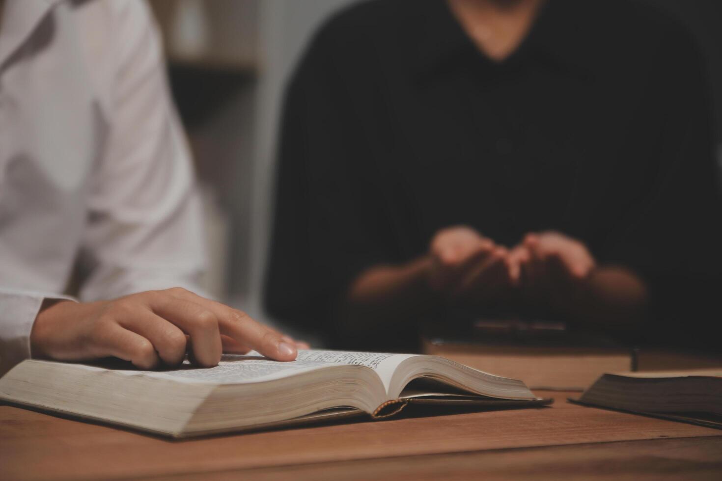 Christian group are praying to god with the bible and sharing the gospel. Concept of faith for god. photo