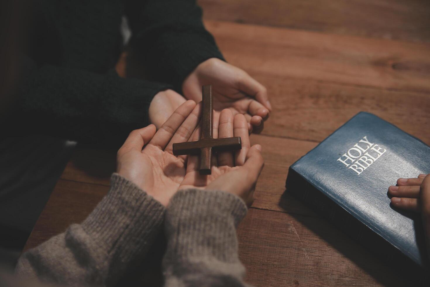 Christian group are praying to god with the bible and sharing the gospel. Concept of faith for god. photo
