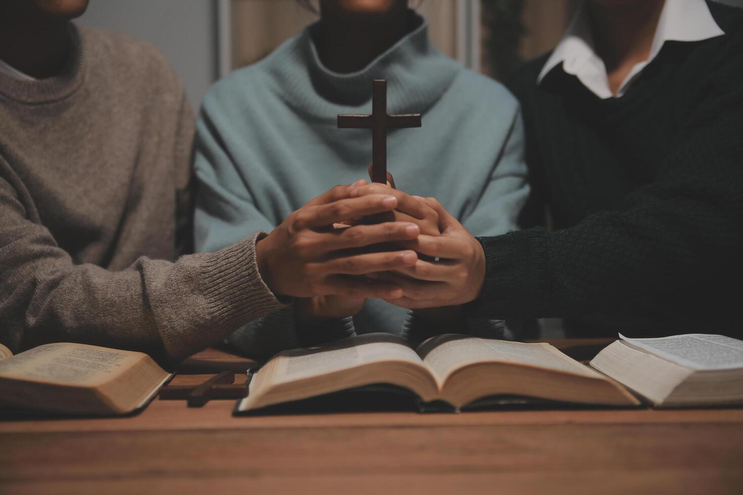 Christian group are praying to god with the bible and sharing the gospel. Concept of faith for god. photo