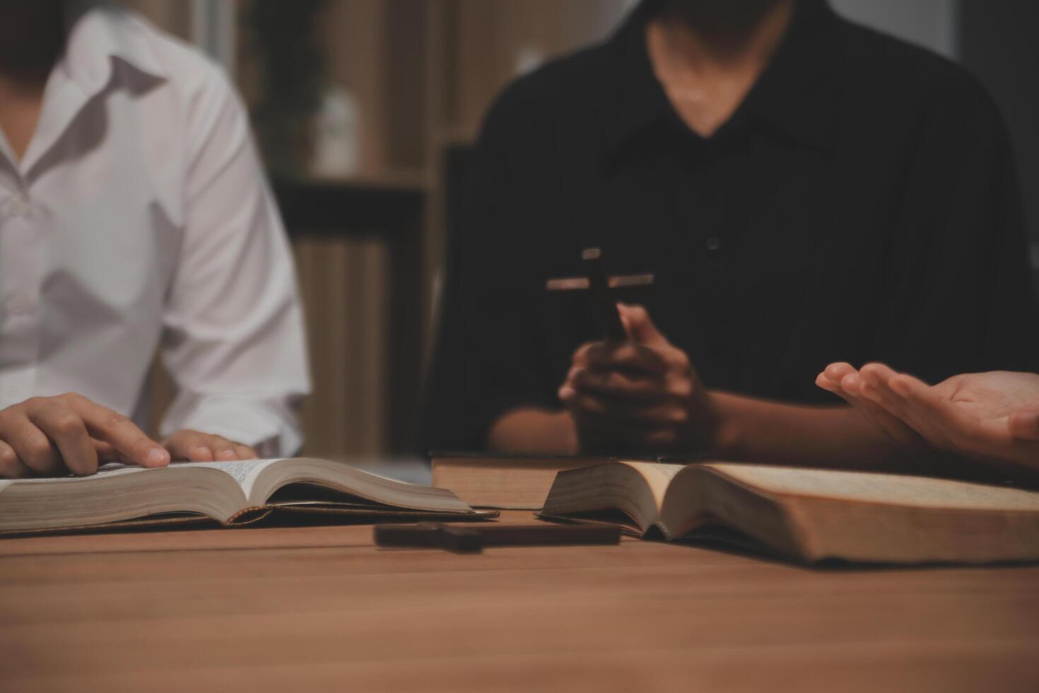 Christian group are praying to god with the bible and sharing the gospel. Concept of faith for god. photo