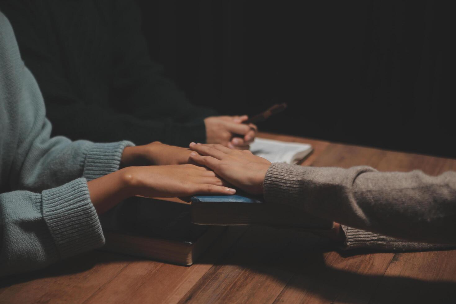 Christian group are praying to god with the bible and sharing the gospel. Concept of faith for god. photo