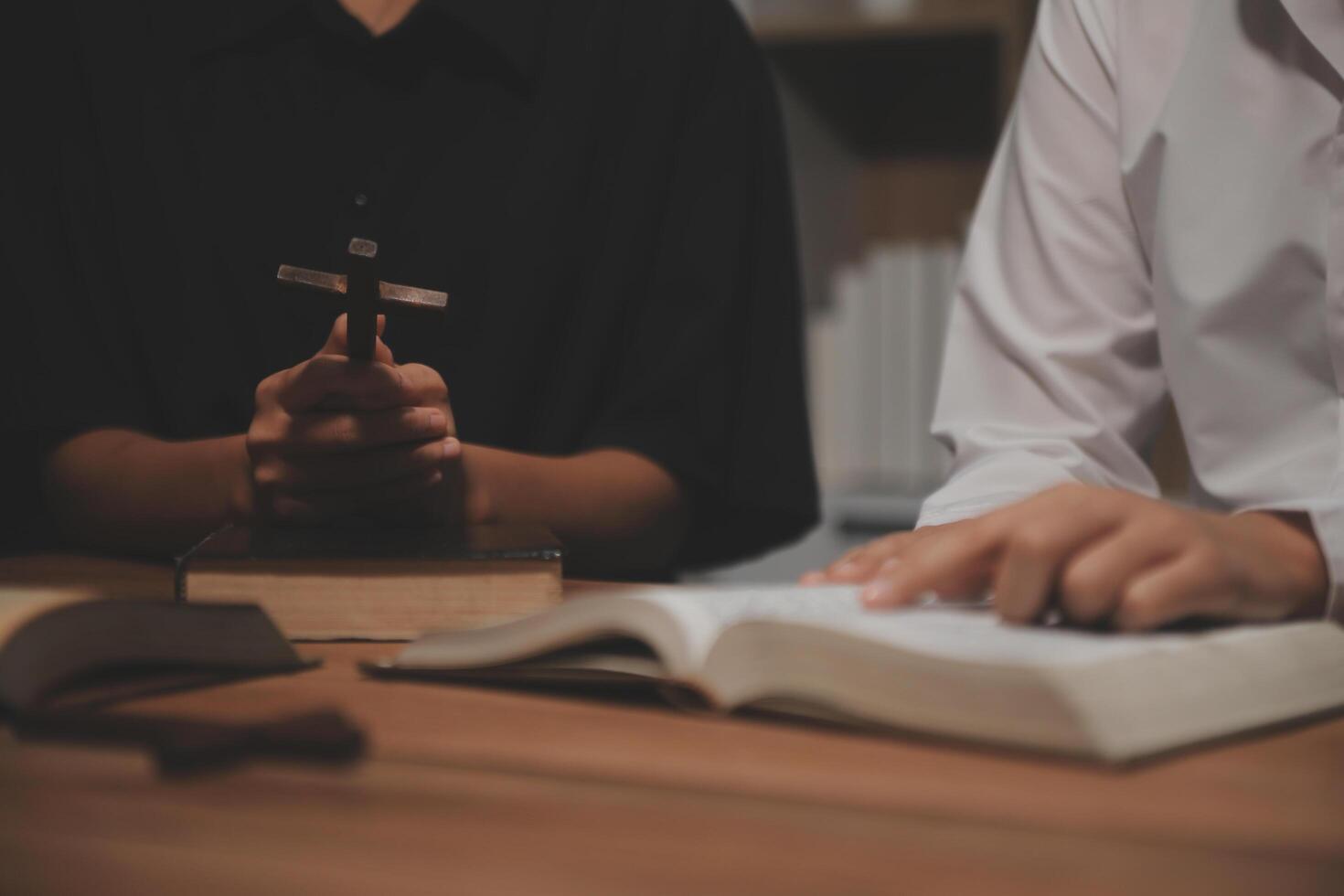 Christian group are praying to god with the bible and sharing the gospel. Concept of faith for god. photo