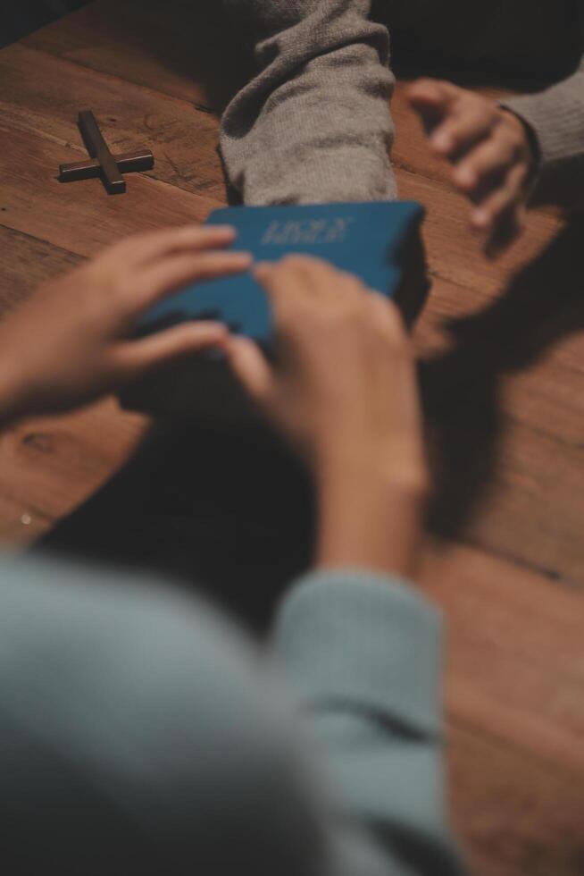 Christian group are praying to god with the bible and sharing the gospel. Concept of faith for god. photo