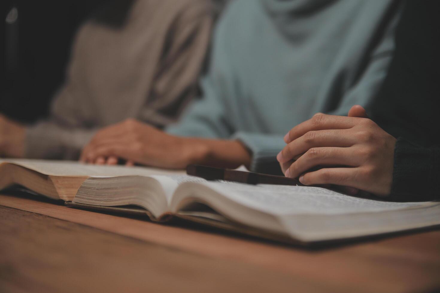 Christian group are praying to god with the bible and sharing the gospel. Concept of faith for god. photo