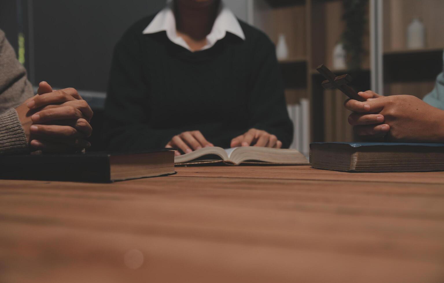 Christian group are praying to god with the bible and sharing the gospel. Concept of faith for god. photo