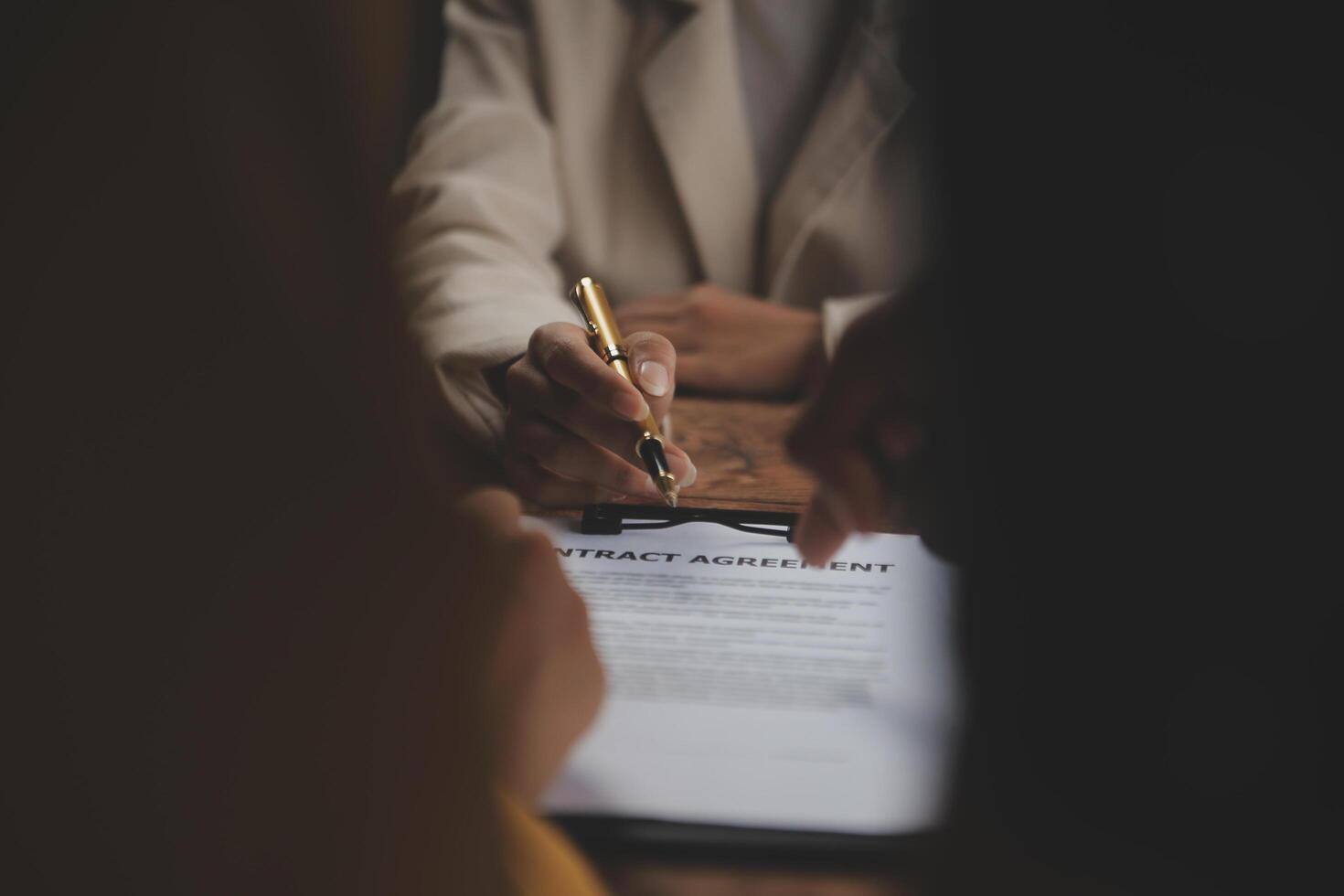 Business and lawyers discussing contract papers with brass scale on desk in office. Law, legal services, advice, justice and law concept picture with film grain effect photo