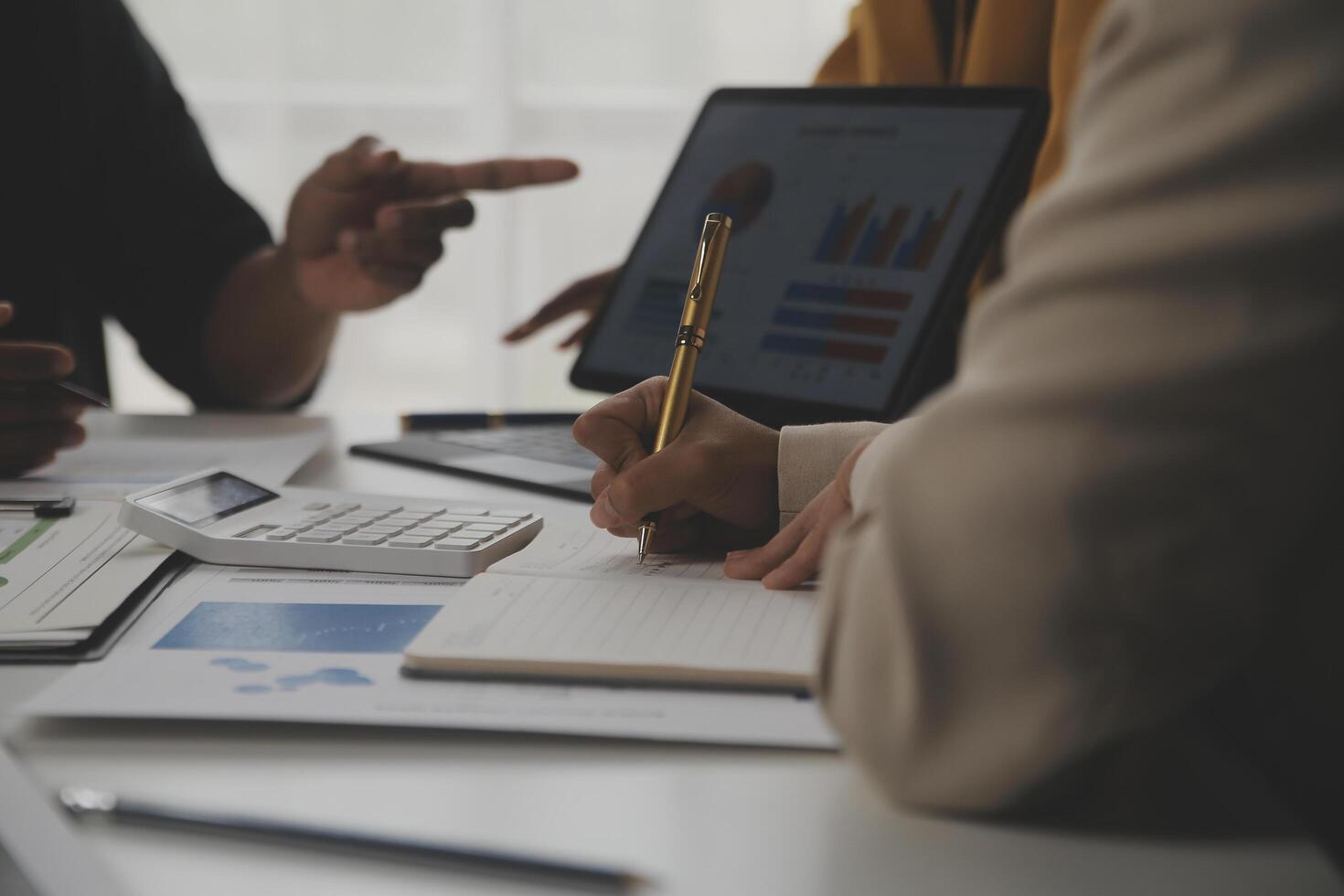 Close up of Business team analyzing income charts and graphs with modern laptop computer. Business analysis and strategy concept. photo