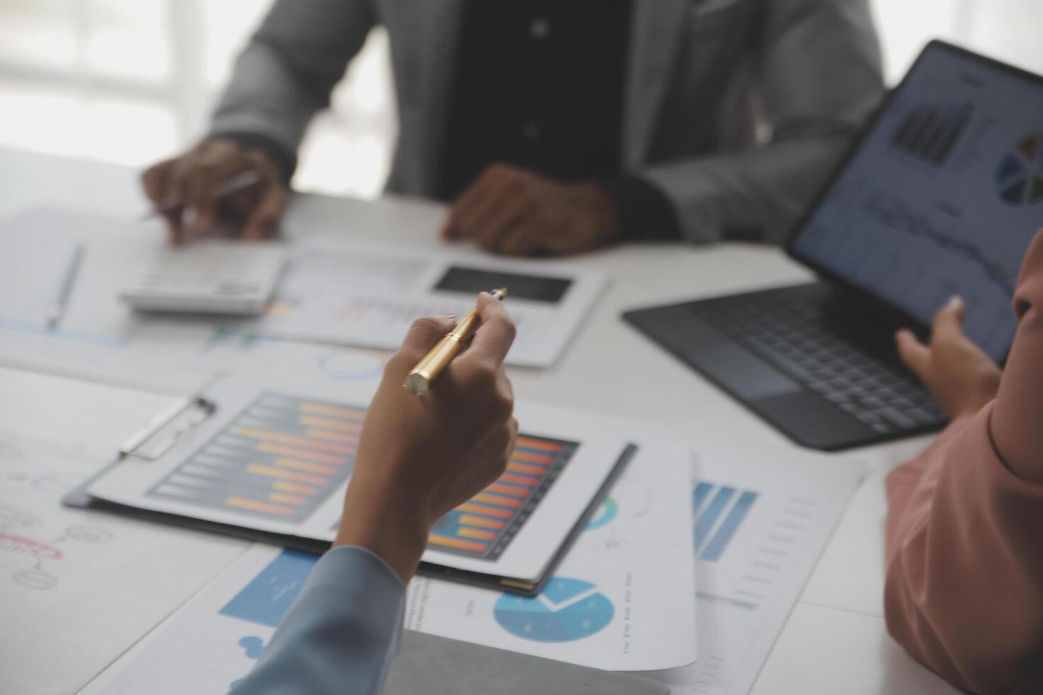 Close up of Business team analyzing income charts and graphs with modern laptop computer. Business analysis and strategy concept. photo