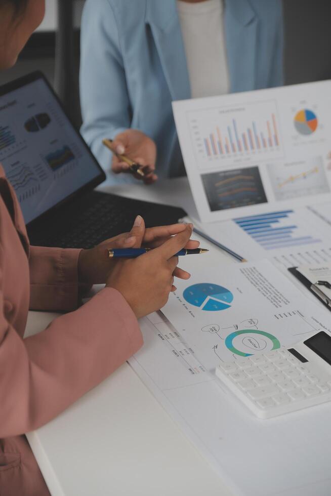 Close up of Business team analyzing income charts and graphs with modern laptop computer. Business analysis and strategy concept. photo