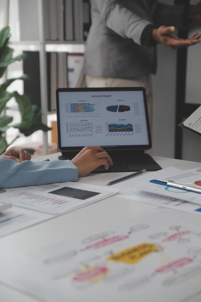Close up of Business team analyzing income charts and graphs with modern laptop computer. Business analysis and strategy concept. photo