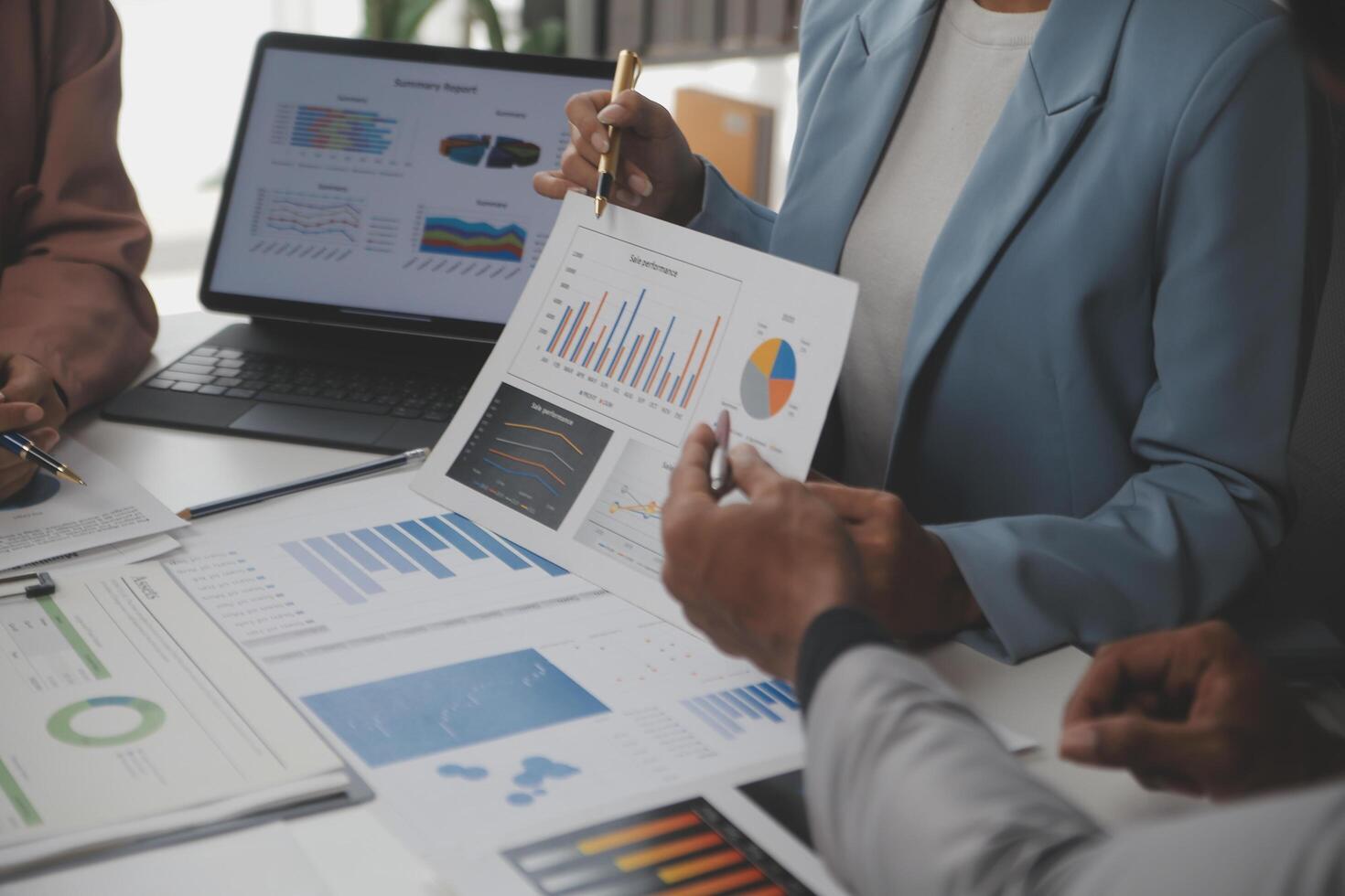 Close up of Business team analyzing income charts and graphs with modern laptop computer. Business analysis and strategy concept. photo