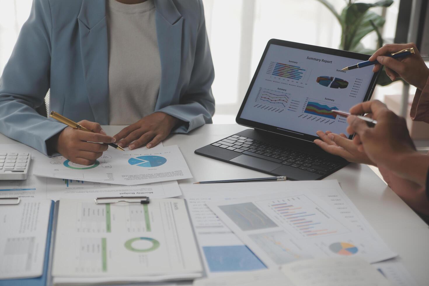 Close up of Business team analyzing income charts and graphs with modern laptop computer. Business analysis and strategy concept. photo