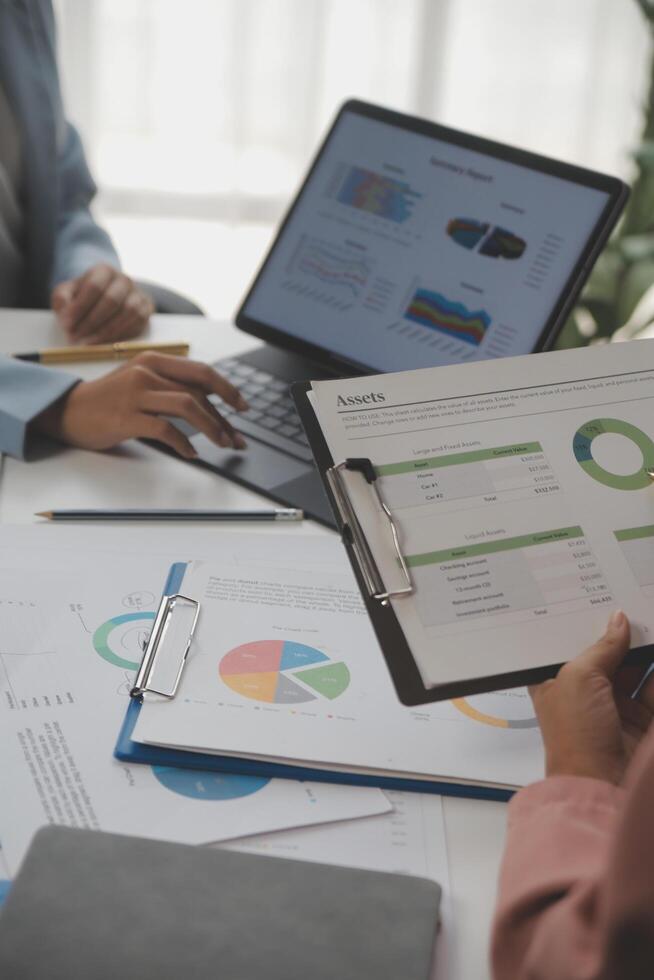 Close up of Business team analyzing income charts and graphs with modern laptop computer. Business analysis and strategy concept. photo