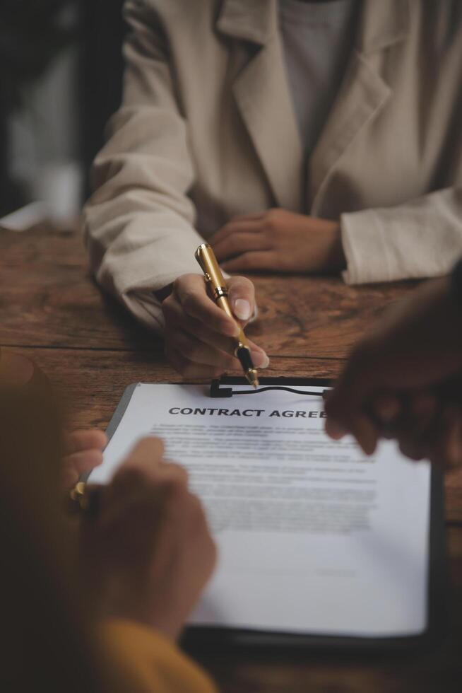 Business and lawyers discussing contract papers with brass scale on desk in office. Law, legal services, advice, justice and law concept picture with film grain effect photo