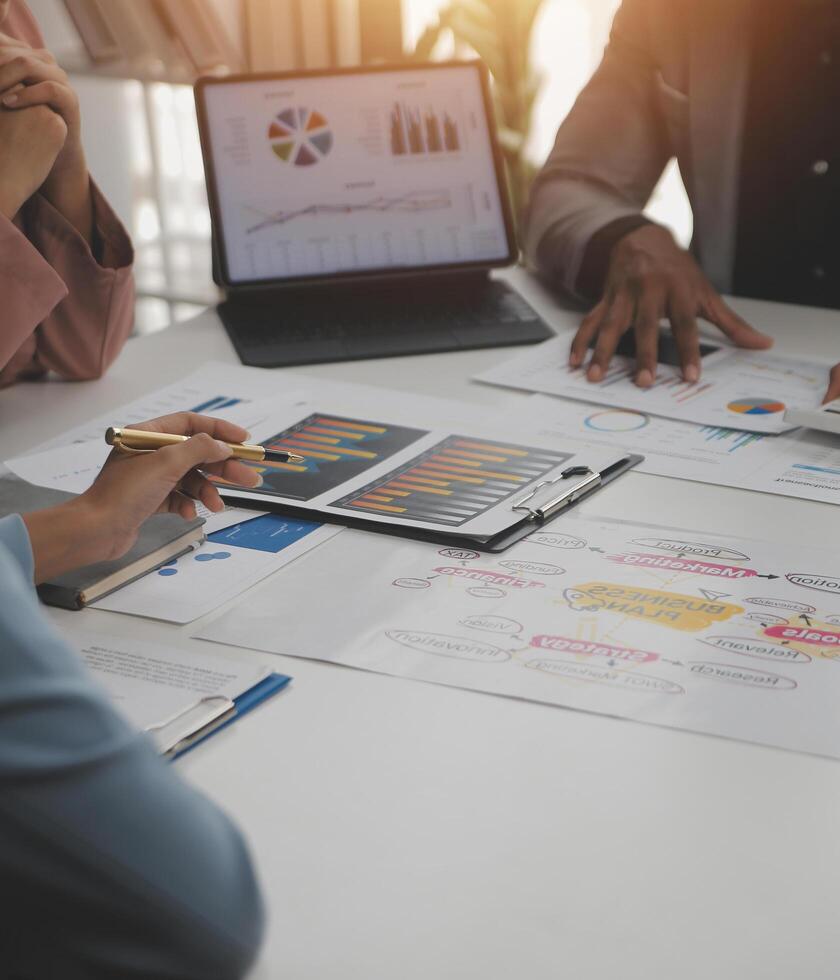 Close up of Business team analyzing income charts and graphs with modern laptop computer. Business analysis and strategy concept. photo