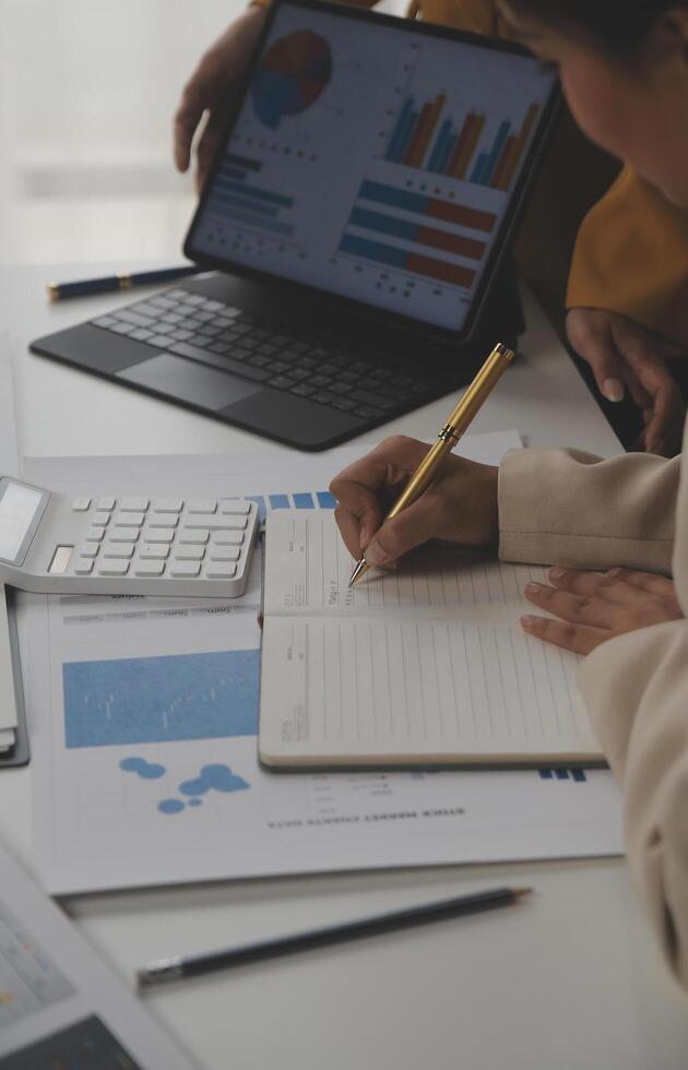 Close up of Business team analyzing income charts and graphs with modern laptop computer. Business analysis and strategy concept. photo