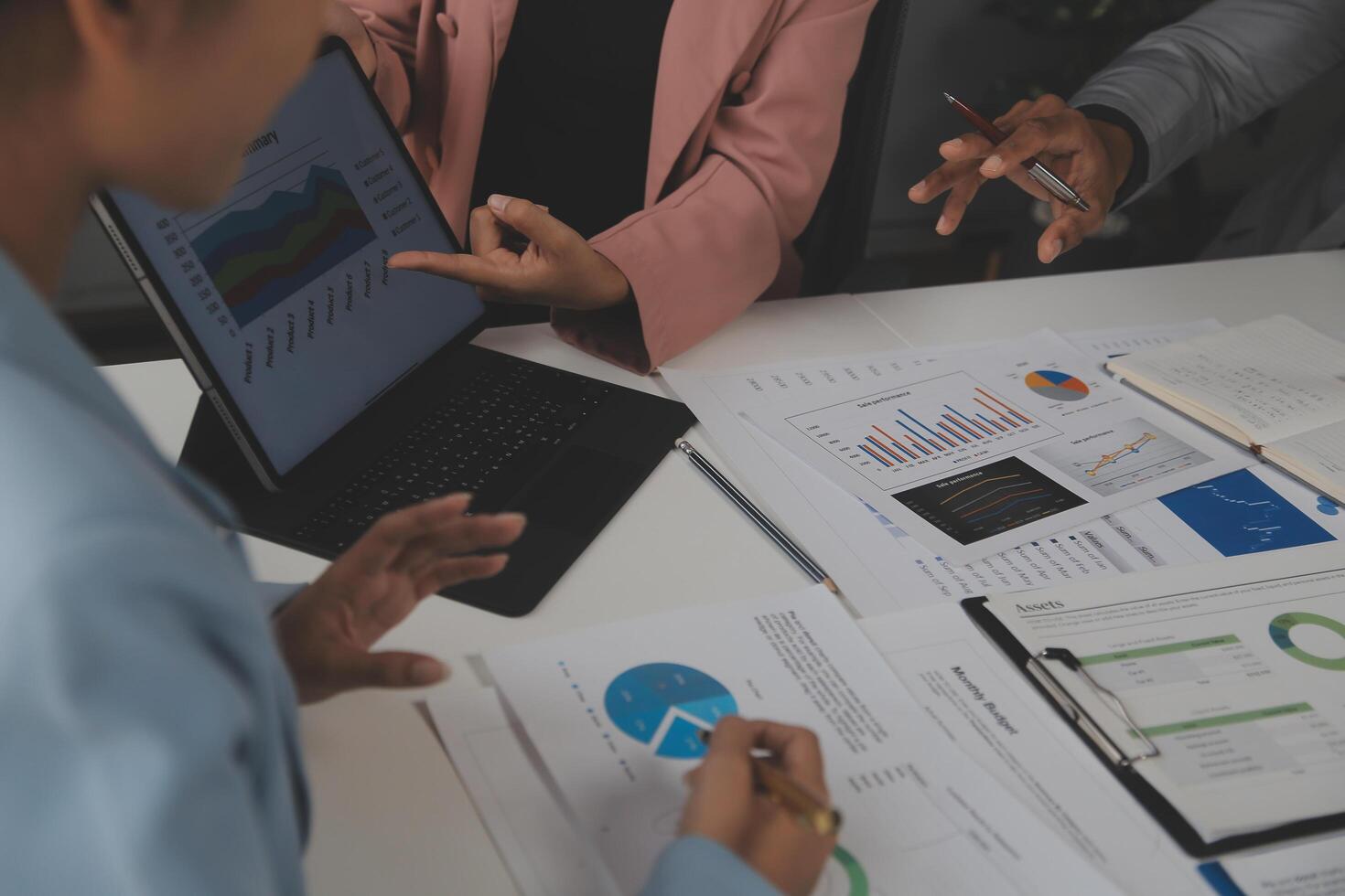 Close up of Business team analyzing income charts and graphs with modern laptop computer. Business analysis and strategy concept. photo