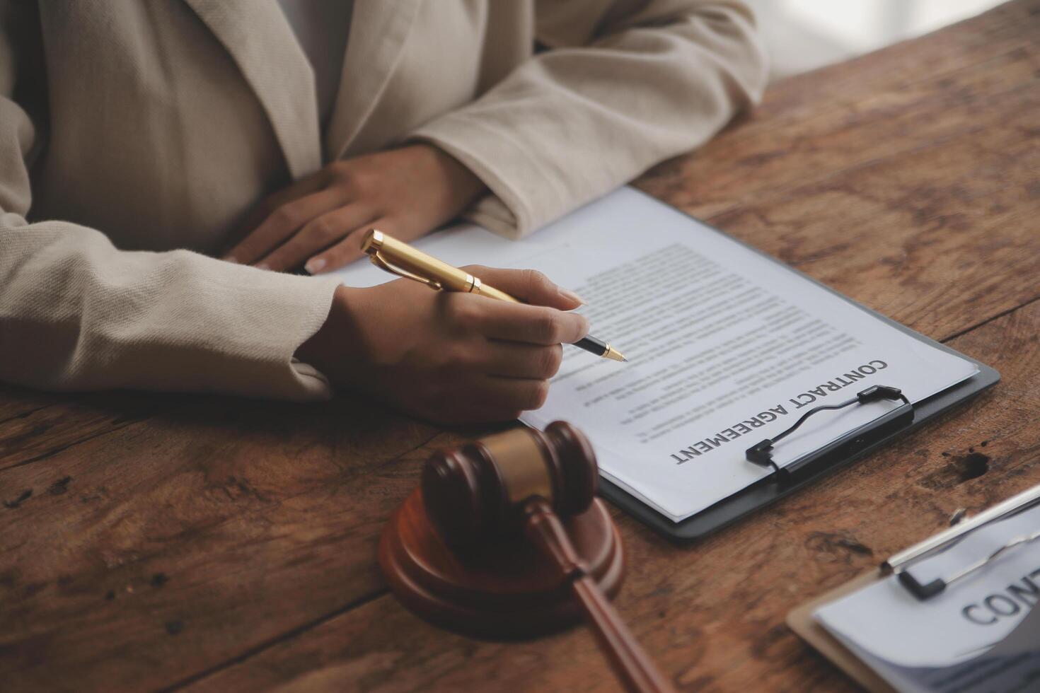 Business and lawyers discussing contract papers with brass scale on desk in office. Law, legal services, advice, justice and law concept picture with film grain effect photo