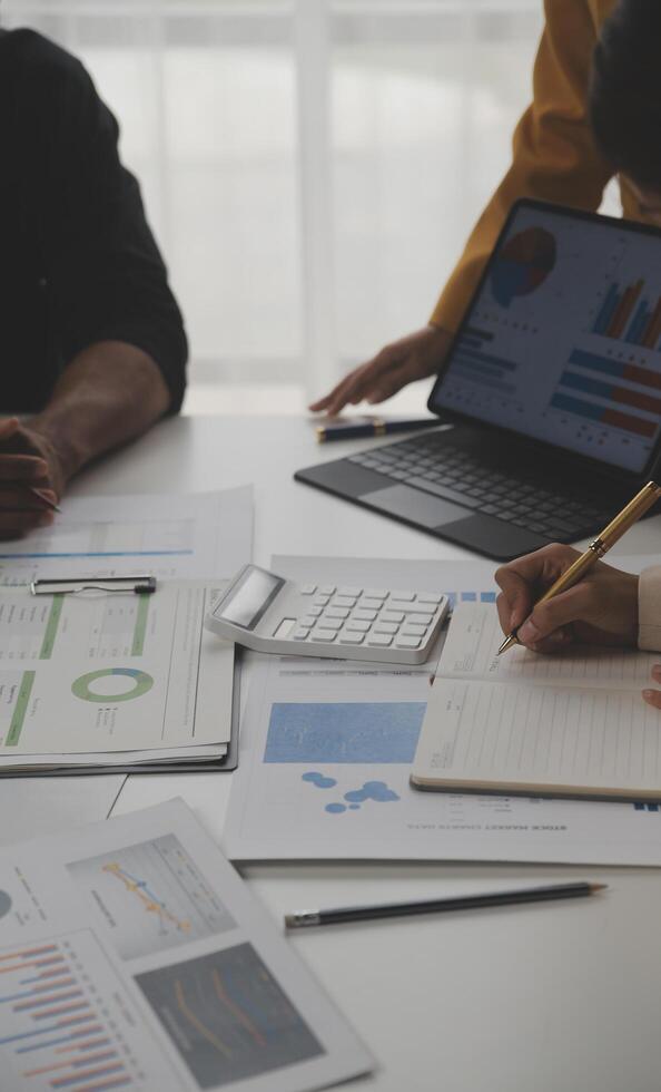 Close up of Business team analyzing income charts and graphs with modern laptop computer. Business analysis and strategy concept. photo