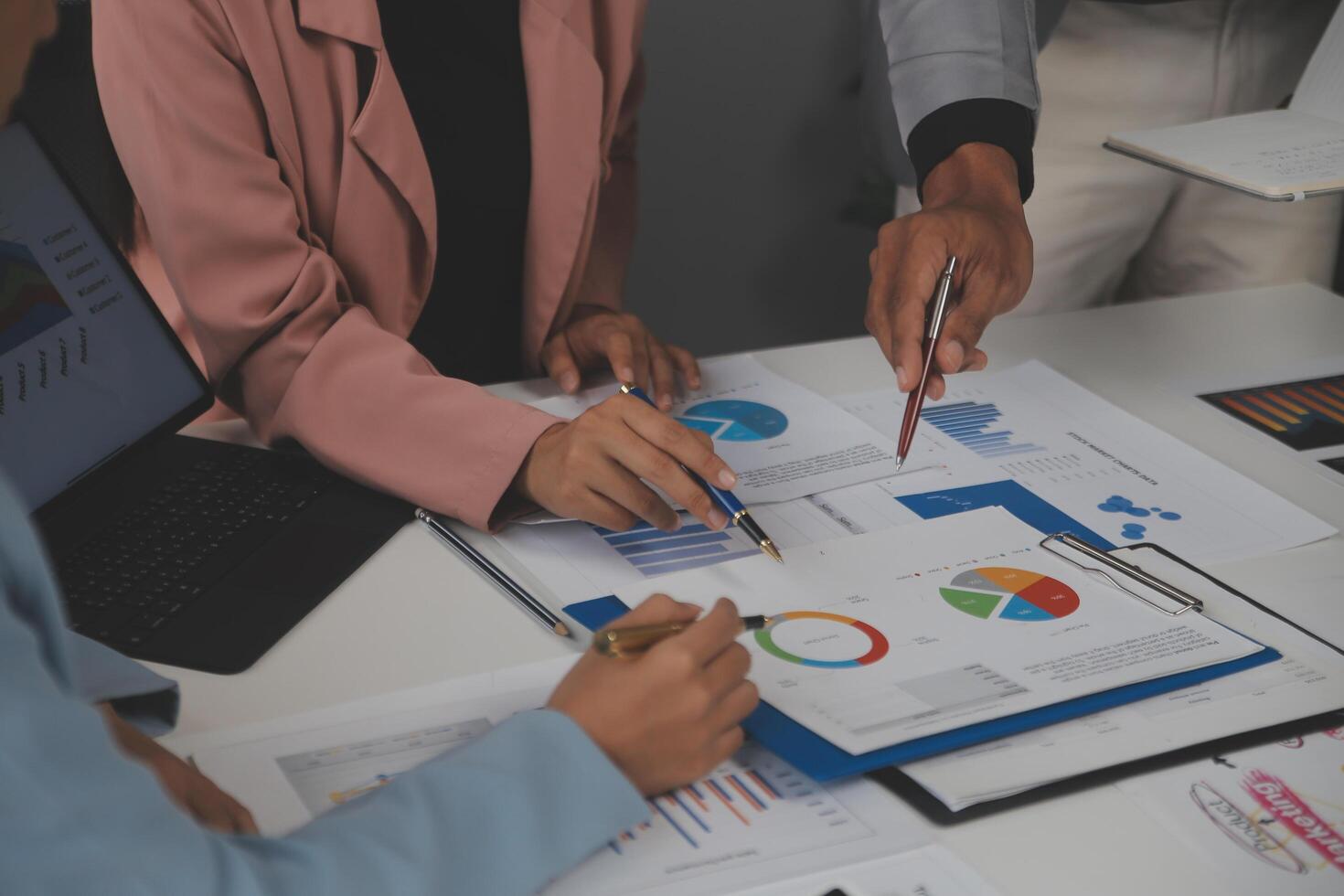 Close up of Business team analyzing income charts and graphs with modern laptop computer. Business analysis and strategy concept. photo