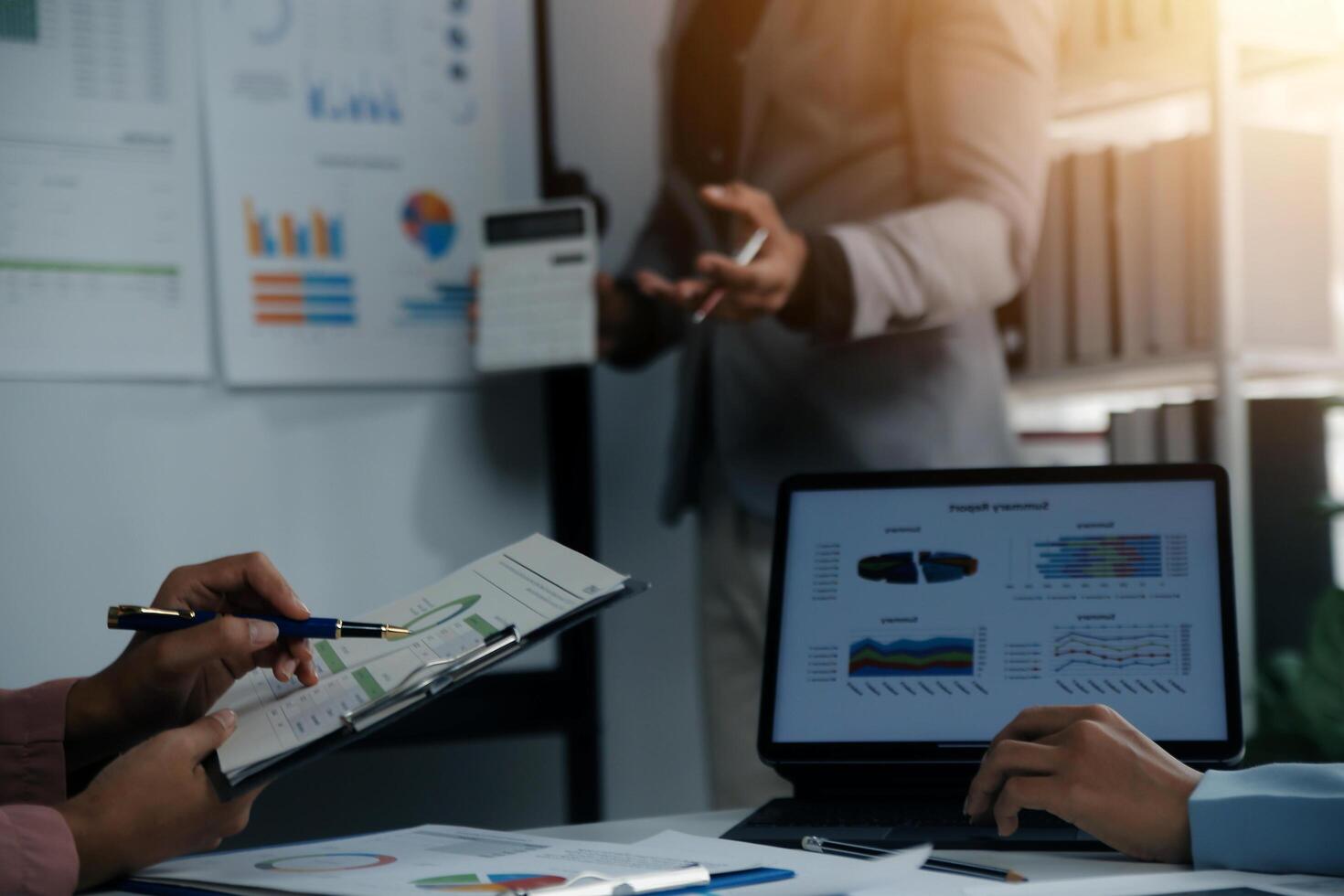 Close up of Business team analyzing income charts and graphs with modern laptop computer. Business analysis and strategy concept. photo