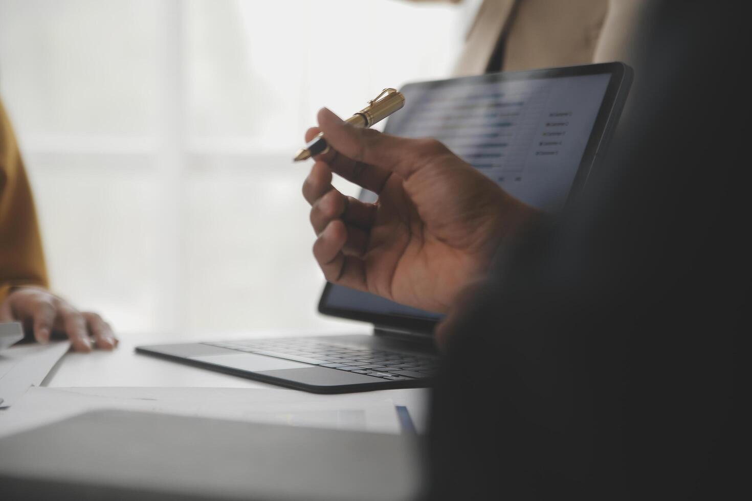 Close up of Business team analyzing income charts and graphs with modern laptop computer. Business analysis and strategy concept. photo