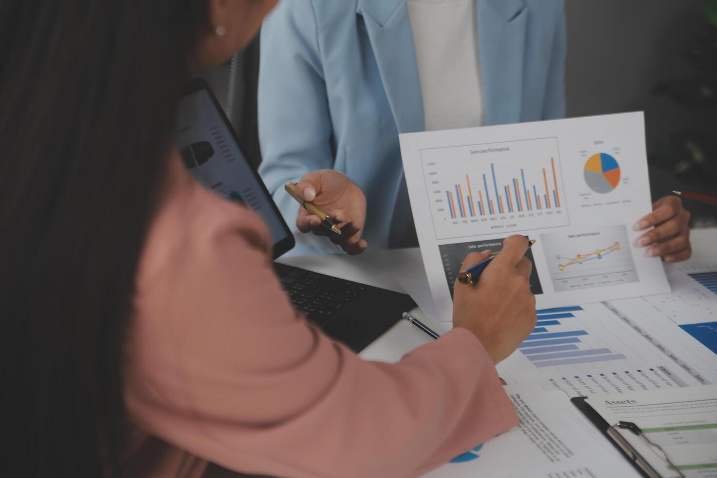 Close up of Business team analyzing income charts and graphs with modern laptop computer. Business analysis and strategy concept. photo