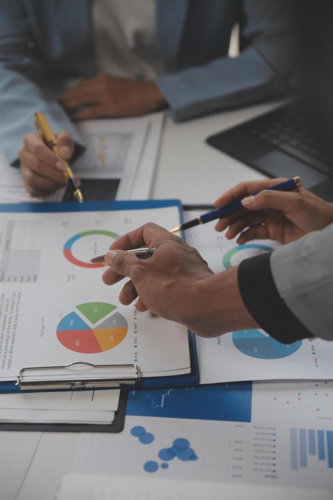 Close up of Business team analyzing income charts and graphs with modern laptop computer. Business analysis and strategy concept. photo