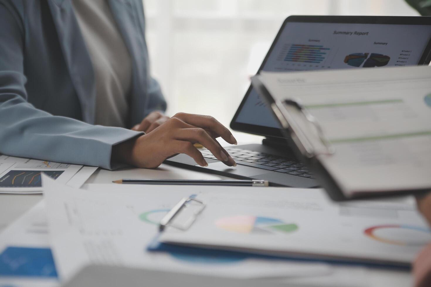 Close up of Business team analyzing income charts and graphs with modern laptop computer. Business analysis and strategy concept. photo