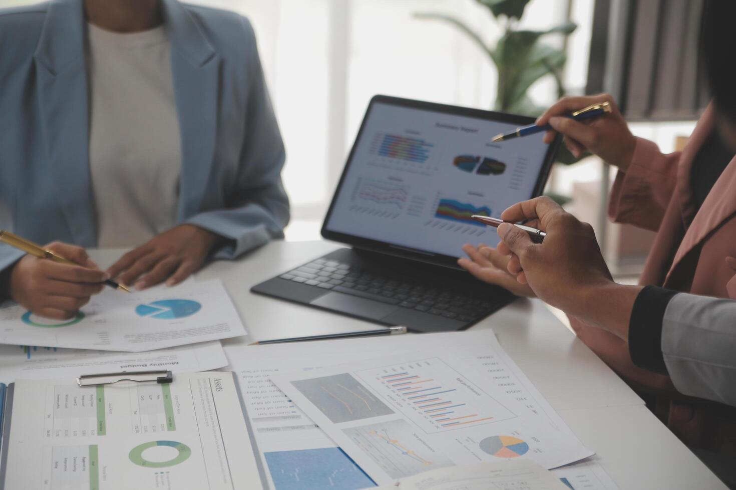Close up of Business team analyzing income charts and graphs with modern laptop computer. Business analysis and strategy concept. photo