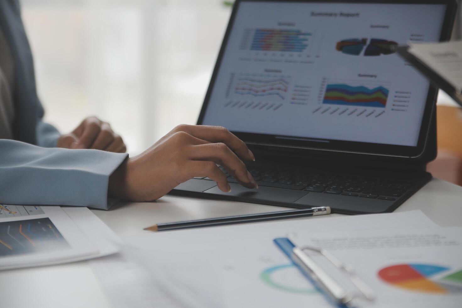 Close up of Business team analyzing income charts and graphs with modern laptop computer. Business analysis and strategy concept. photo