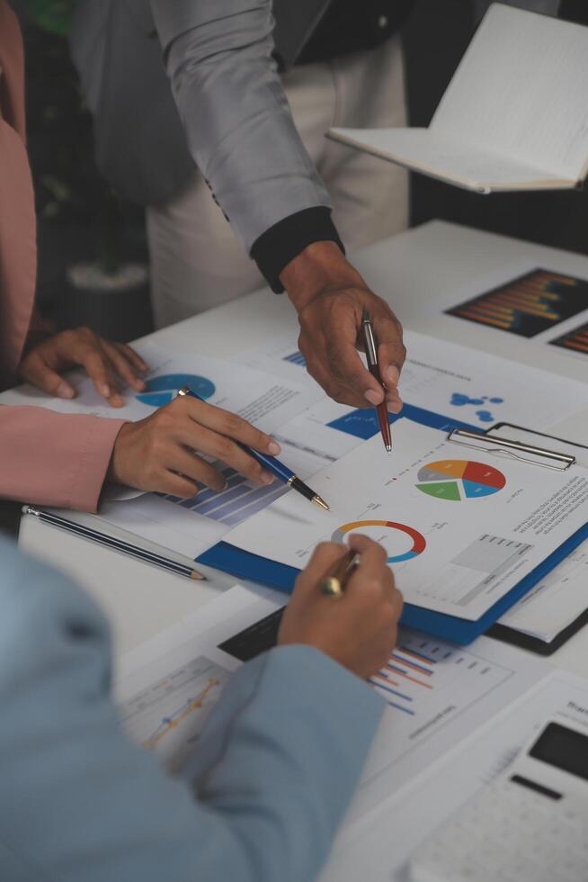 Close up of Business team analyzing income charts and graphs with modern laptop computer. Business analysis and strategy concept. photo