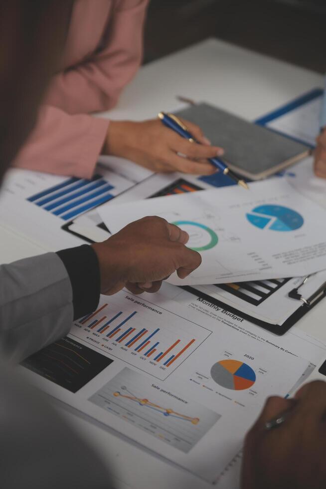 Close up of Business team analyzing income charts and graphs with modern laptop computer. Business analysis and strategy concept. photo