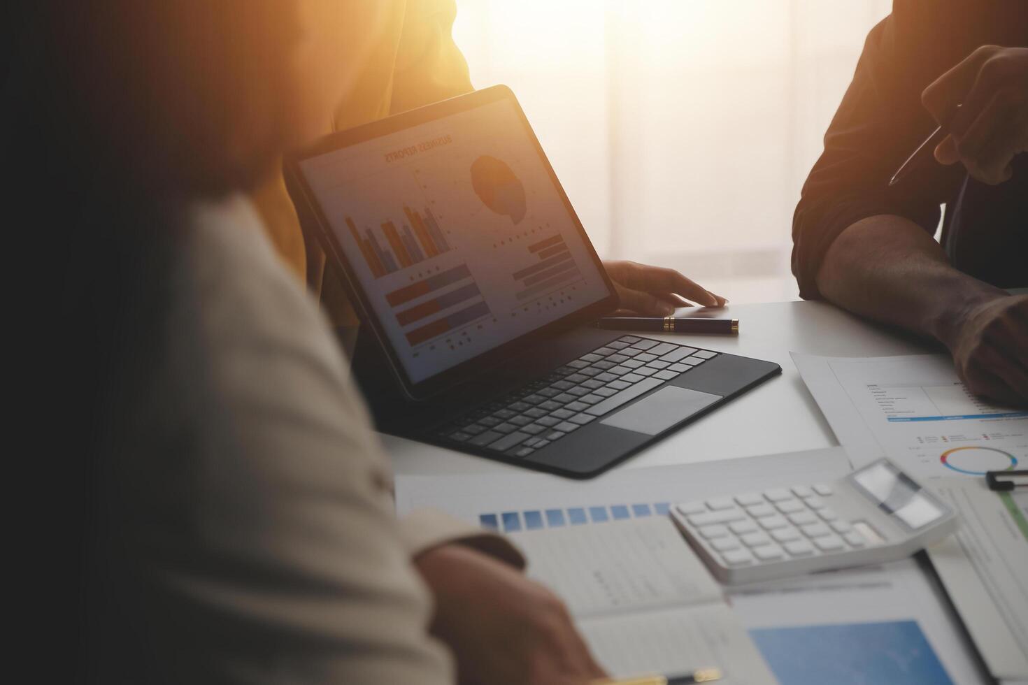 Close up of Business team analyzing income charts and graphs with modern laptop computer. Business analysis and strategy concept. photo