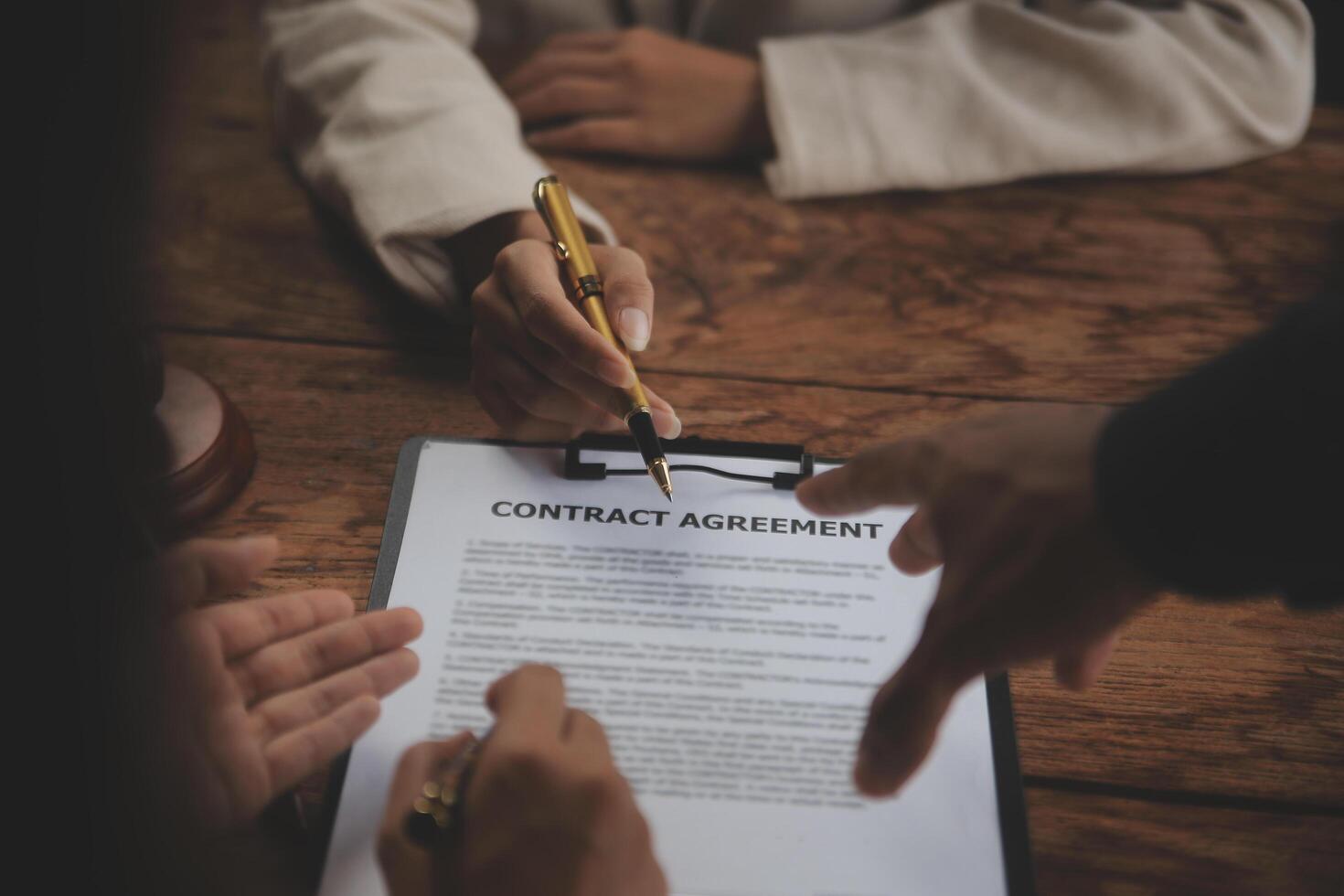 Business and lawyers discussing contract papers with brass scale on desk in office. Law, legal services, advice, justice and law concept picture with film grain effect photo