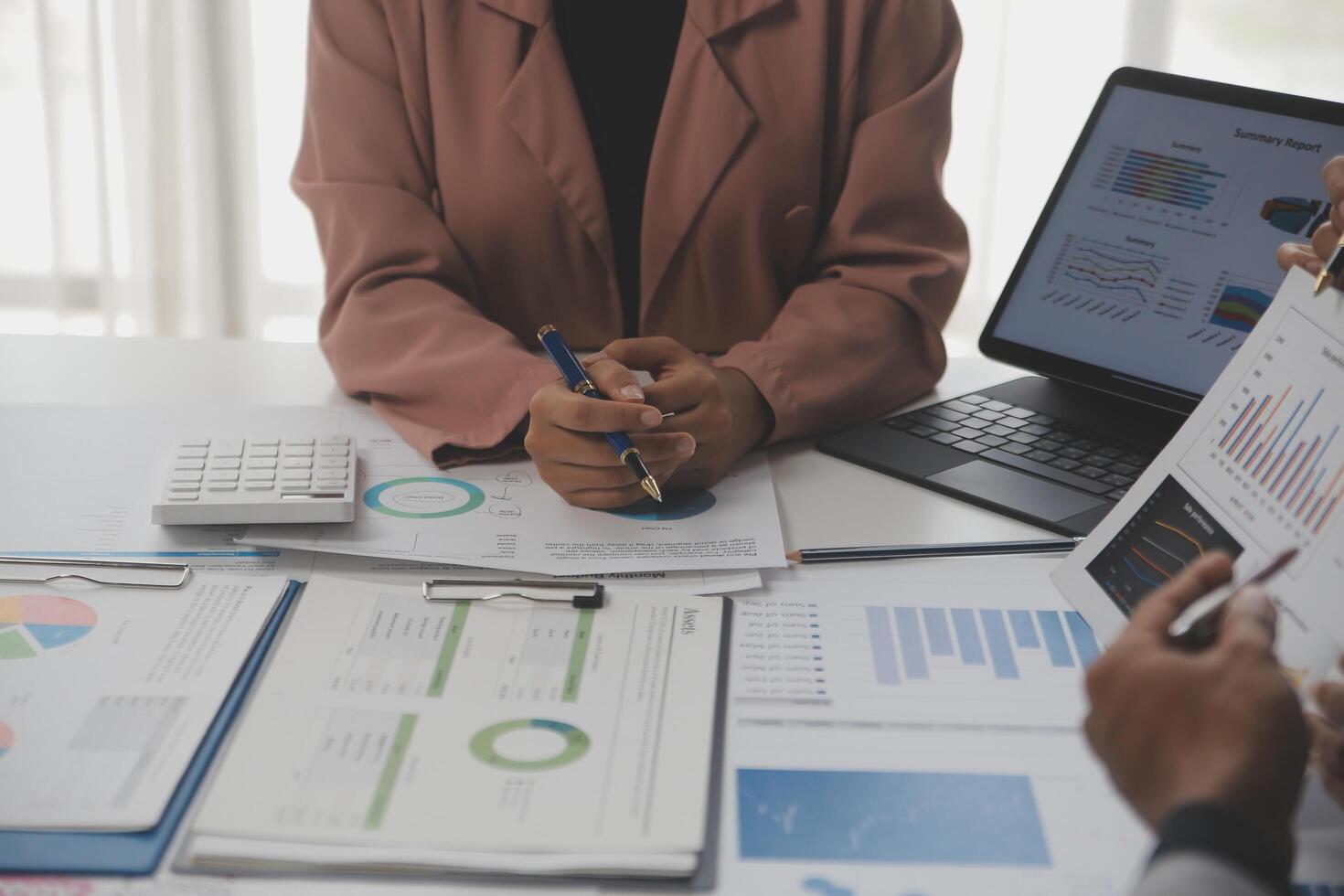 Close up of Business team analyzing income charts and graphs with modern laptop computer. Business analysis and strategy concept. photo