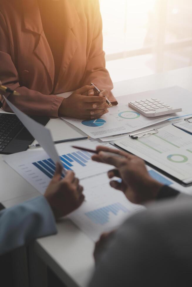 Close up of Business team analyzing income charts and graphs with modern laptop computer. Business analysis and strategy concept. photo