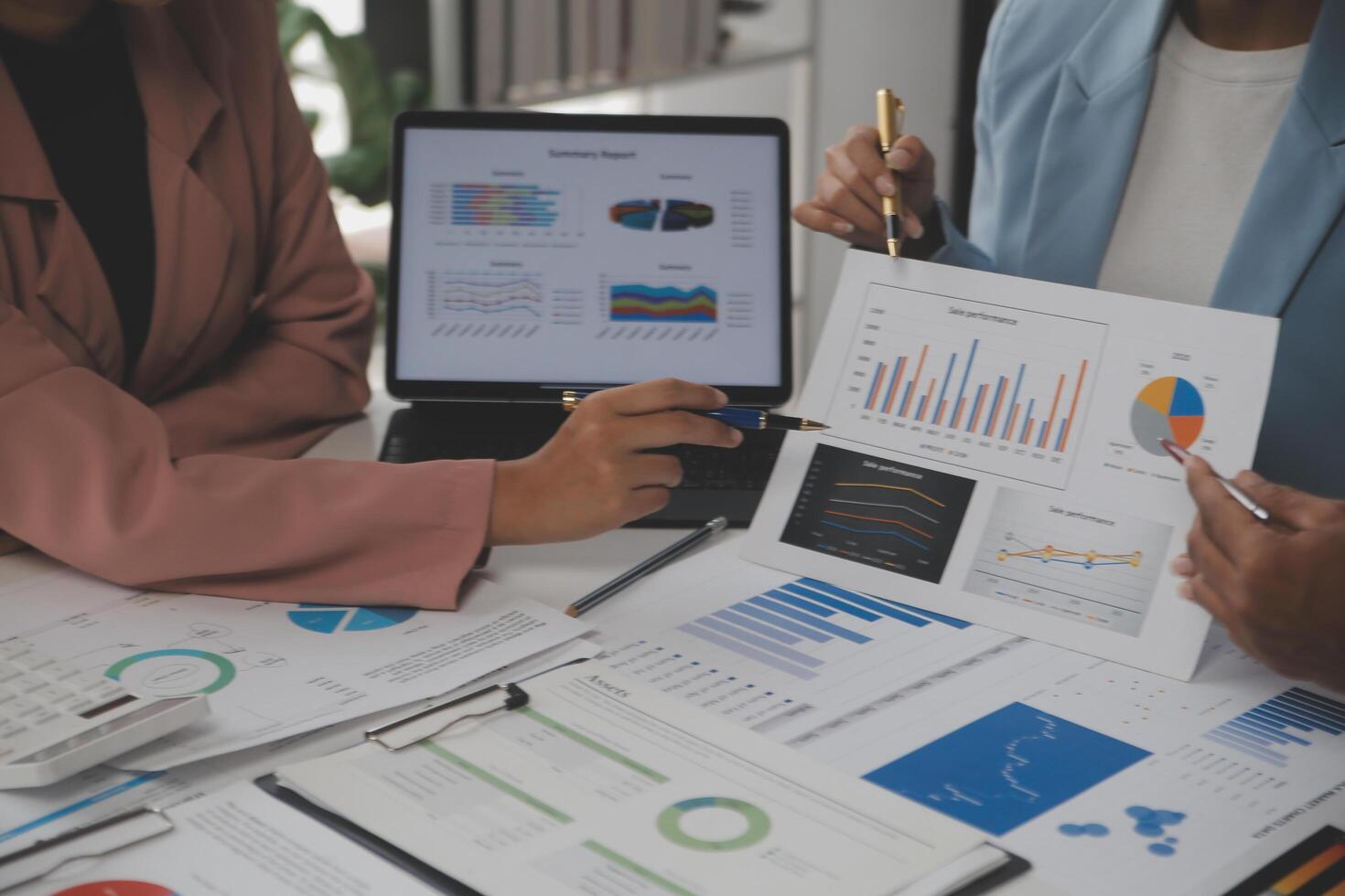Close up of Business team analyzing income charts and graphs with modern laptop computer. Business analysis and strategy concept. photo