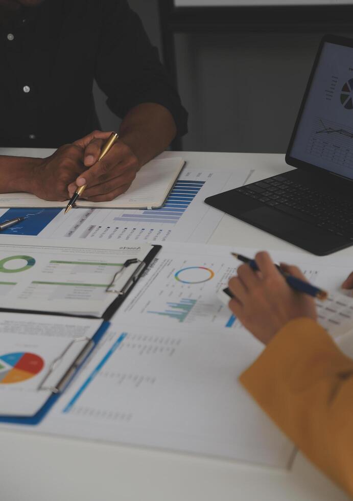 Close up of Business team analyzing income charts and graphs with modern laptop computer. Business analysis and strategy concept. photo