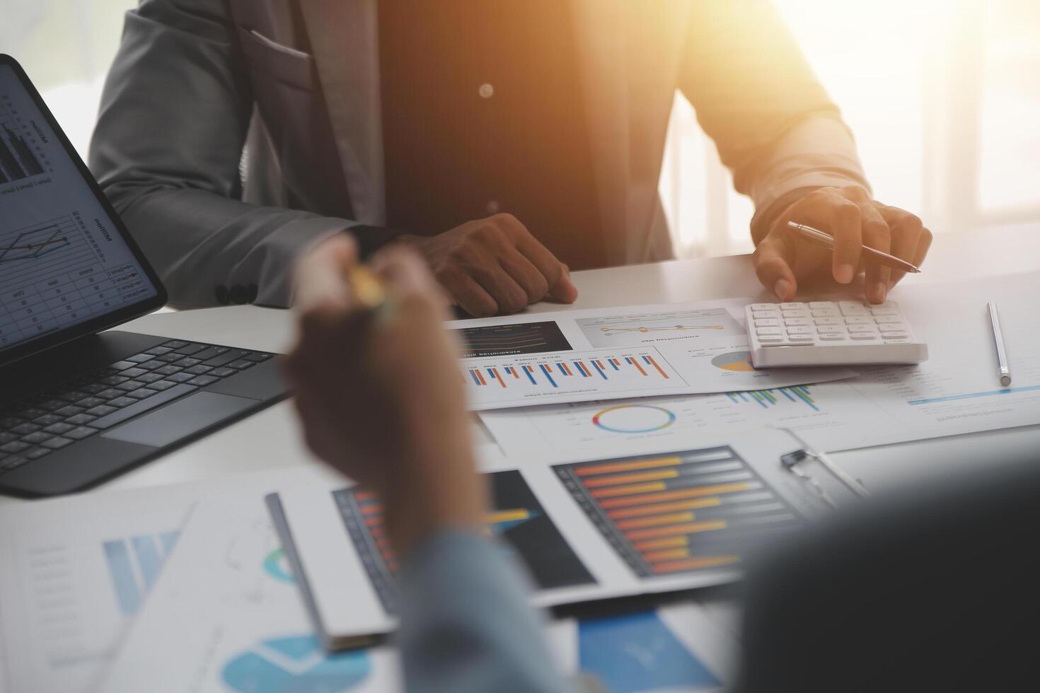 Close up of Business team analyzing income charts and graphs with modern laptop computer. Business analysis and strategy concept. photo